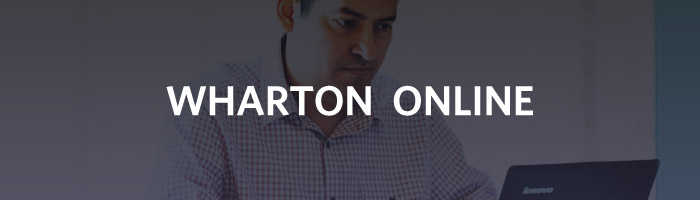 A person working on a Lenovo laptop with the text "WHARTON ONLINE" overlaid on the image.