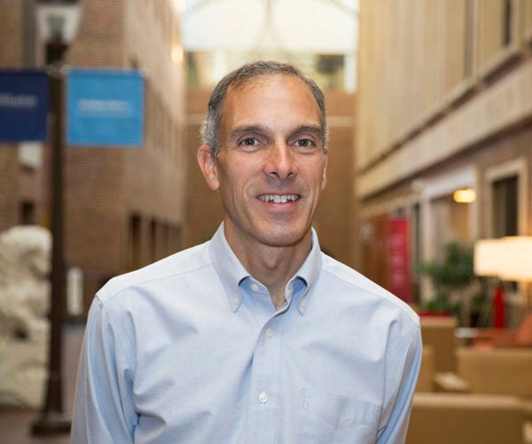 Headshot of Prof. Cachon in a light blue shirt standing inside a Wharton building