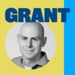 Black and white headshot of a person with a bald head, wearing a collared shirt, against a yellow background. The word "GRANT" is displayed in large blue letters above.