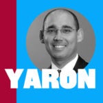 A grayscale headshot of a person wearing glasses and a suit, set against a background divided between maroon and blue, with the name "Yaron" in bold white letters across the bottom.