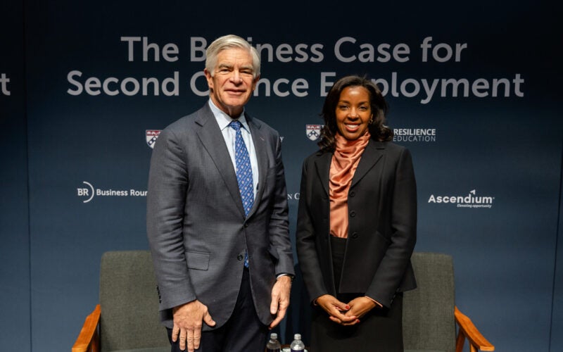 A man and a woman are standing in business attire against a backdrop that reads "The Business Case for Second Chance Employment," with logos for Business Roundtable and Ascendium.